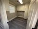Efficient laundry room featuring built-in cabinets for ample storage and modern flooring at 215 Buck Run, Loganville, GA 30052