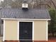 Durable and well-maintained outbuilding provides extra storage and features double doors at 215 Buck Run, Loganville, GA 30052