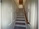 Staircase featuring white walls, wood trim and hardwood stairs at 215 Buck Run, Loganville, GA 30052