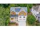 Aerial view of a home with beautiful landscaping, a gray roof and a long driveway surrounded by lush trees at 2717 Skyland Dr, Brookhaven, GA 30319