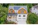 Aerial view of a two-story home with cedar shake roof, lush greenery, and a charming front porch at 2717 Skyland Dr, Brookhaven, GA 30319