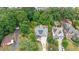 Wide aerial view of two neighboring homes with lush landscaping surrounded by dense trees at 2717 Skyland Dr, Brookhaven, GA 30319