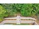 Backyard featuring professional landscaping, stone terraces and a stairway surrounded by lush trees at 2717 Skyland Dr, Brookhaven, GA 30319