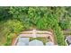 Aerial view of a backyard featuring professional landscaping, stone terraces and a stairway surrounded by lush trees at 2717 Skyland Dr, Brookhaven, GA 30319
