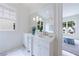 Bright bathroom with a double vanity, large mirror, and elegant lighting fixtures at 2717 Skyland Dr, Brookhaven, GA 30319