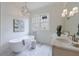Bright bathroom with freestanding tub, double vanity, elegant chandelier, and natural light at 2717 Skyland Dr, Brookhaven, GA 30319