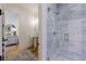 Modern tiled shower featuring sleek fixtures and glass door leading to powder room at 2717 Skyland Dr, Brookhaven, GA 30319