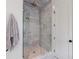 Walk-in shower featuring marble tile, a glass enclosure, and a built-in niche at 2717 Skyland Dr, Brookhaven, GA 30319