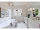 Modern bathroom with soaking tub, marble floors, double vanity and contemporary lighting at 2717 Skyland Dr, Brookhaven, GA 30319