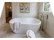 Modern bathroom featuring a freestanding tub, marble floors, and stylish fixtures at 2717 Skyland Dr, Brookhaven, GA 30319