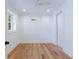 Cozy bedroom features hardwood floors, two windows, ceiling fan, and white walls at 2717 Skyland Dr, Brookhaven, GA 30319