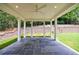Spacious covered patio with a stone floor, ceiling fan, and view of the backyard landscaping at 2717 Skyland Dr, Brookhaven, GA 30319