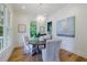 Bright dining room with hardwood floors, modern chandelier, and views of the outdoors at 2717 Skyland Dr, Brookhaven, GA 30319