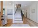 Bright entryway with wood floors, staircase, and open access to other rooms creates an inviting and spacious feel at 2717 Skyland Dr, Brookhaven, GA 30319