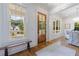 Charming entryway features a wood door, a bench, and large windows offering views of the front yard at 2717 Skyland Dr, Brookhaven, GA 30319