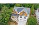 Exterior of a two-story white home with a shingled roof and a two-car garage surrounded by lush trees at 2717 Skyland Dr, Brookhaven, GA 30319