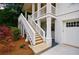 Close-up of the exterior staircase leading to the covered porch, complemented by the attached garage at 2717 Skyland Dr, Brookhaven, GA 30319