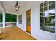 Charming front porch featuring wooden flooring, white columns, and a view of the lush greenery at 2717 Skyland Dr, Brookhaven, GA 30319