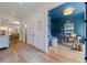 Hallway view into a blue painted home office with beautiful wood floors and neutral wall colors throughout at 2717 Skyland Dr, Brookhaven, GA 30319