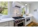 Modern kitchen features stainless-steel appliances, white marble backsplash, and plenty of counter space at 2717 Skyland Dr, Brookhaven, GA 30319
