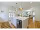 Bright kitchen with island, farmhouse sink, stainless steel appliances, and white cabinets at 2717 Skyland Dr, Brookhaven, GA 30319