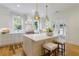 Bright kitchen island featuring white marble countertop, seating, and stainless steel appliances at 2717 Skyland Dr, Brookhaven, GA 30319