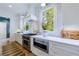 Bright kitchen features stainless steel appliances, marble backsplash, and white cabinets at 2717 Skyland Dr, Brookhaven, GA 30319