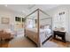 Spacious main bedroom with a four poster bed, neutral colors, and hardwood floors at 2717 Skyland Dr, Brookhaven, GA 30319