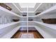 Walk-in pantry with white shelving, wooden baskets, and hardwood flooring at 2717 Skyland Dr, Brookhaven, GA 30319