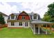 Home's backyard featuring a covered patio area and well-manicured lawn at 2717 Skyland Dr, Brookhaven, GA 30319