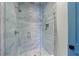 Large glass-enclosed shower features light gray tile and modern fixtures at 2717 Skyland Dr, Brookhaven, GA 30319
