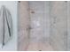 This elegant walk-in shower features marble tile, glass enclosure, and sleek fixtures at 2717 Skyland Dr, Brookhaven, GA 30319