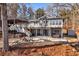 Home's outdoor space features a patio with a hot tub, hammock, fire pit, and wooded views at 405 Miller Rd, Covington, GA 30014
