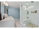 Modern bathroom showcasing glass shower with bench and stylish tile flooring at 405 Miller Rd, Covington, GA 30014