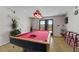 Game room with a red pool table, custom lighting, and backyard views at 405 Miller Rd, Covington, GA 30014