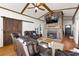 Cozy living room with a brick fireplace, wood beams, and a rustic barn door feature at 405 Miller Rd, Covington, GA 30014