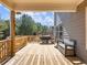 This lovely back porch features wood flooring, a built-in bench, and wooded views at 6145 Stargazer Way, Cumming, GA 30028