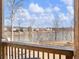 Enjoy lake views from this wood porch with wood railing and peaceful scenery at 6145 Stargazer Way, Cumming, GA 30028