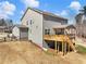 Backyard view featuring a spacious deck, landscaped yard, and the exterior of the home at 6145 Stargazer Way, Cumming, GA 30028