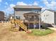 A spacious backyard with a wooden deck, stairs, and patio area, ideal for outdoor gatherings at 6145 Stargazer Way, Cumming, GA 30028