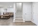 Finished basement boasts wood-look floors, neutral walls, and a staircase to the main level at 6145 Stargazer Way, Cumming, GA 30028