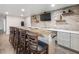 Finished basement bar with brick accents, wooden countertop, gray cabinets, and seating for entertaining at 6145 Stargazer Way, Cumming, GA 30028