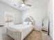 Cozy bedroom with a plush rug, neutral paint, a window with blinds, and an upholstered headboard at 6145 Stargazer Way, Cumming, GA 30028