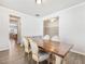 Elegant dining room featuring a large wooden table, four chairs, and views into adjacent rooms at 6145 Stargazer Way, Cumming, GA 30028