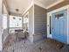 Inviting front porch with brick flooring and comfortable seating area, perfect for enjoying the outdoors at 6145 Stargazer Way, Cumming, GA 30028