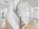 Hallway featuring wood floors leading to the staircase and an open view of the home's interior at 6145 Stargazer Way, Cumming, GA 30028