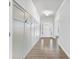 Light-filled hallway with board and batten walls, hardwood floors, and views of the entrance and living areas at 6145 Stargazer Way, Cumming, GA 30028