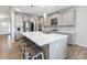 Modern kitchen with gray cabinetry, stainless steel appliances, and a spacious white quartz island with seating at 6145 Stargazer Way, Cumming, GA 30028