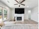 Inviting living room with a fireplace and natural light streaming through large windows at 6145 Stargazer Way, Cumming, GA 30028