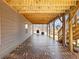 View of the covered patio featuring brick flooring, access to the backyard, and outdoor dining or seating at 6145 Stargazer Way, Cumming, GA 30028